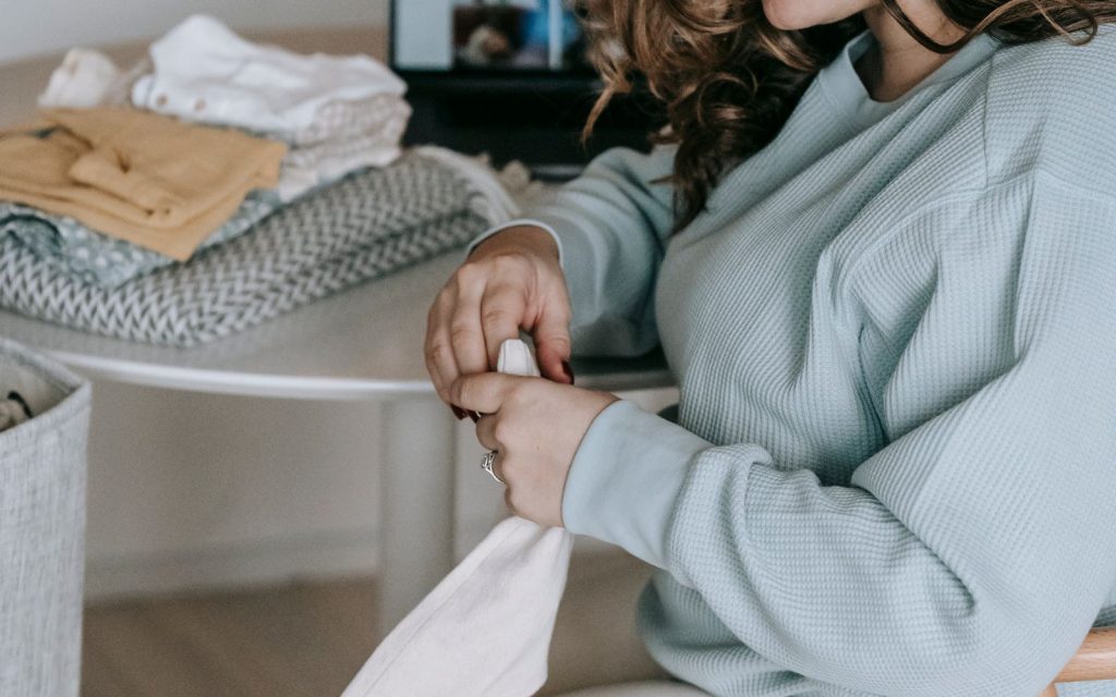 Vêtements de bébé pliés pour préparer la valise de maternité